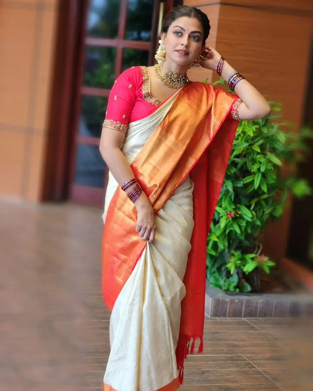 Anusree Nair Wearing Beautiful Earrings Jewellery White Saree Orange Blouse